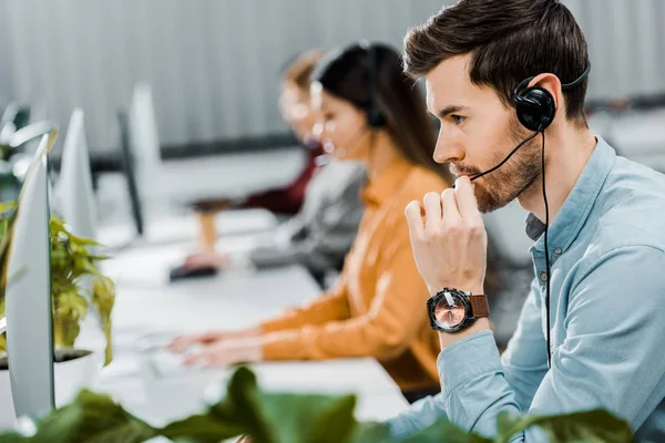 call center operator in headset working in office
